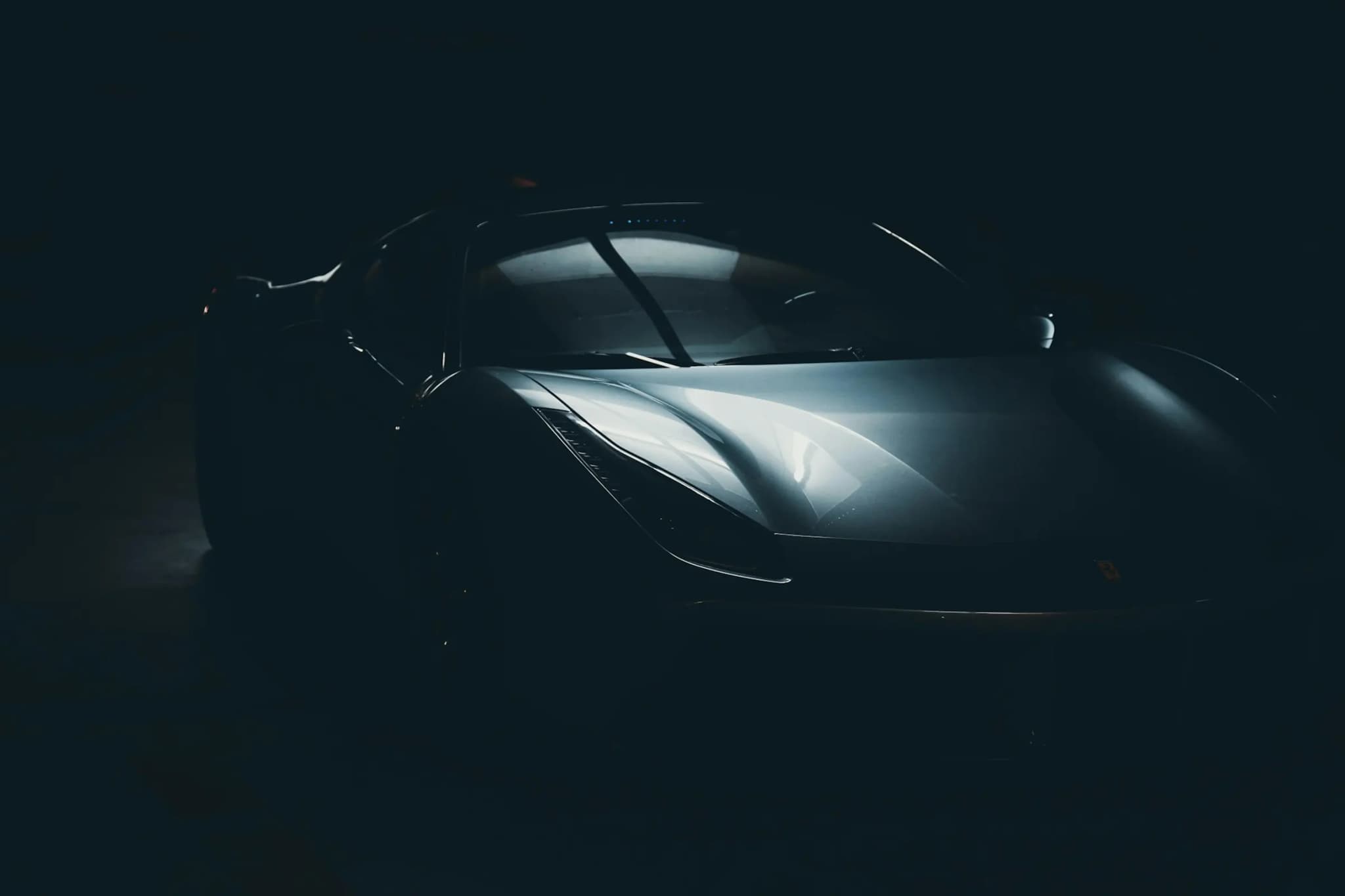 Dark sports car silhouette in a moody low-lit room