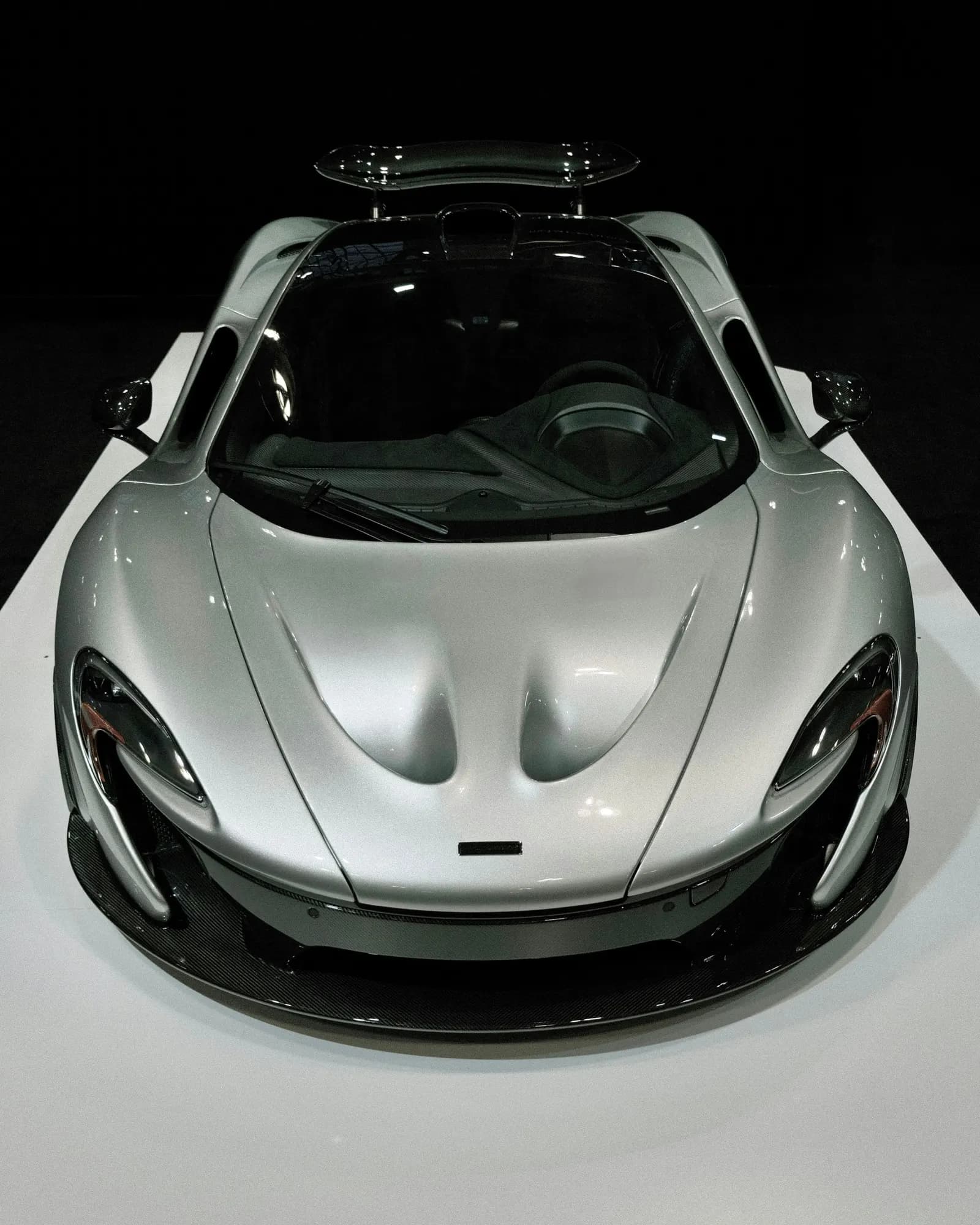 Silver McLaren P1, front view against a dark background