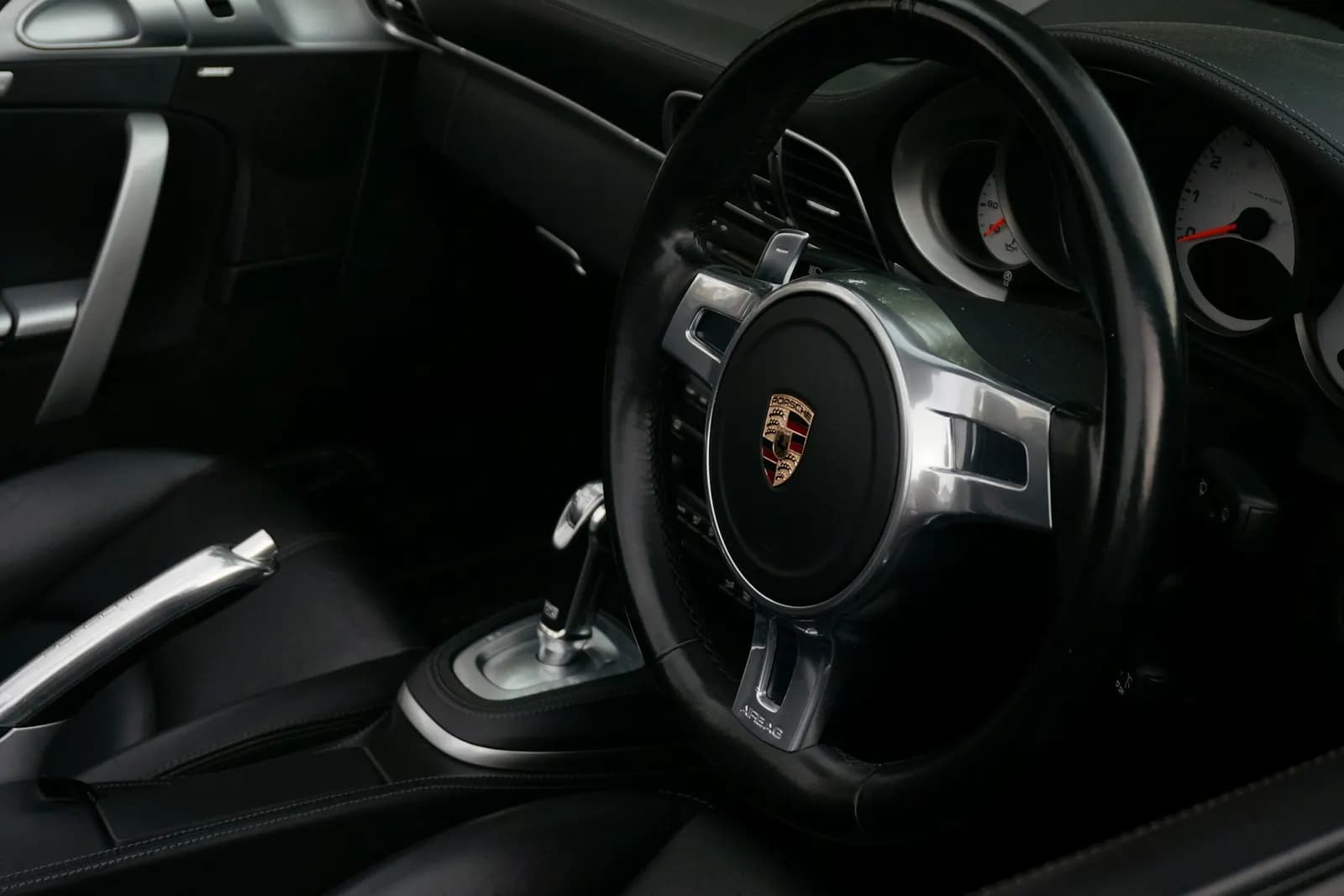 Porsche interior with steering wheel and dashboard
